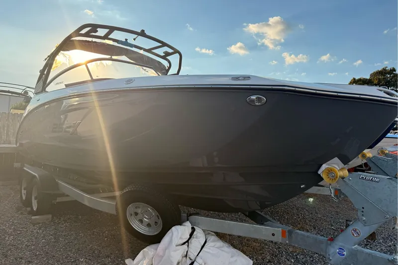 Slide: The Image of 2025 Yamaha Boats 252XE on trailer, sunlit, showcasing sleek design and modern features. - 1