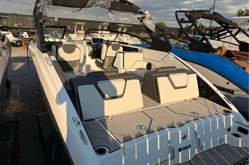 Slide: The Image of 2025 Yamaha Boats 252XE, luxury interior, spacious seating, modern design, docked outdoors. - 3