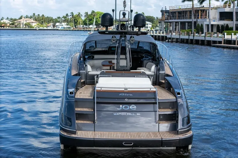 Slide: The Image of Luxurious 2015 Riva 63 yacht docked in scenic waterfront location. - 10
