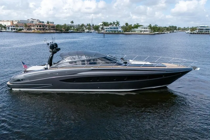 Slide: The Image of 2015 Riva 63 yacht on calm water, showcasing sleek design and luxury features. - 15