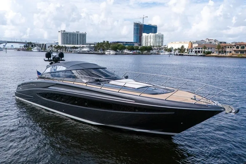 Slide: The Image of Luxurious 2015 Riva 63 yacht cruising on a scenic waterfront with city skyline. - 16