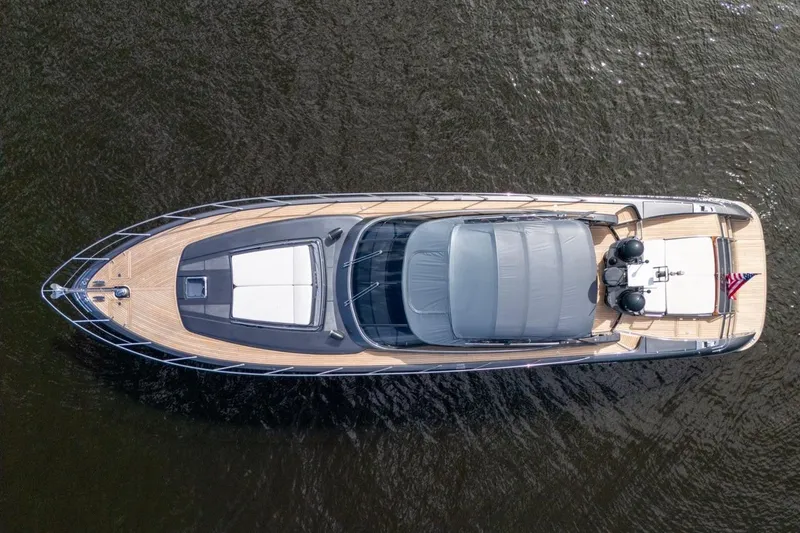 Slide: The Image of Overhead view of 2015 Riva 63 yacht on water, showcasing sleek design and luxury features. - 20