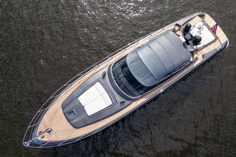 Slide: The Image of Overhead view of a 2015 Riva 63 yacht on water, showcasing sleek design and luxury features. - 21