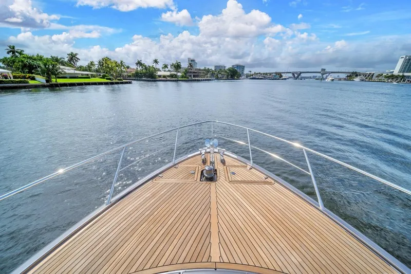Slide: The Image of Bow view of 2015 Riva 63 yacht cruising on a scenic waterway. - 26