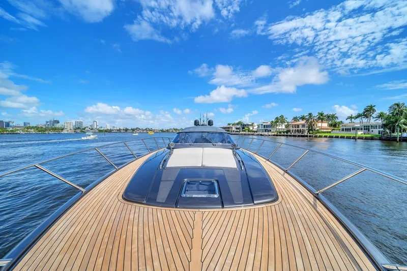 Slide: The Image of Luxurious 2015 Riva 63 yacht cruising on a sunny day with scenic waterfront views. - 29