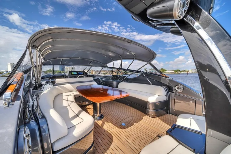 Slide: The Image of Luxurious 2015 Riva 63 yacht interior with elegant seating and wooden table under canopy. - 35