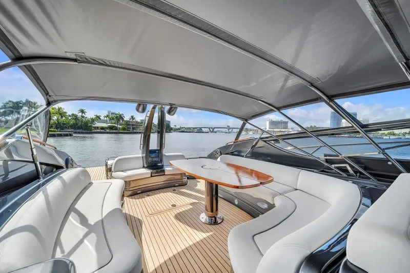 Slide: The Image of Luxurious 2015 Riva 63 yacht interior with elegant seating and scenic waterfront view. - 36