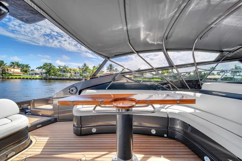 Slide: The Image of Luxurious 2015 Riva 63 yacht interior with elegant seating and scenic waterfront view. - 37