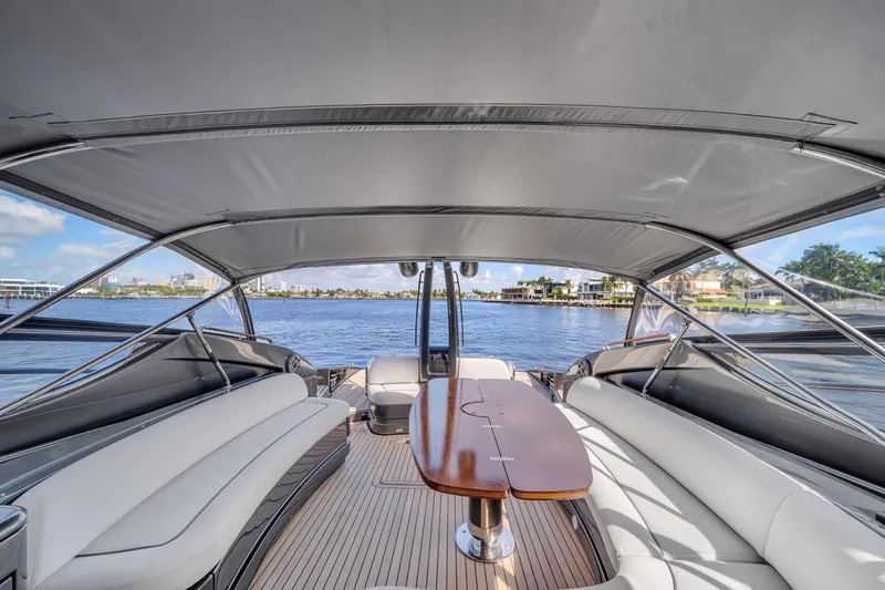 Slide: The Image of Luxurious 2015 Riva 63 yacht interior with elegant seating and scenic waterfront view. - 38
