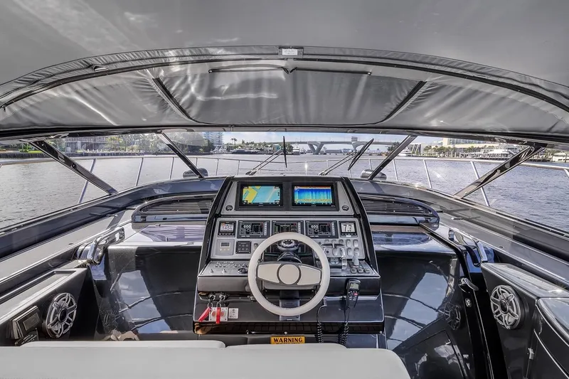 Slide: The Image of Cockpit view of a 2015 Riva 63 yacht with advanced navigation controls. - 40