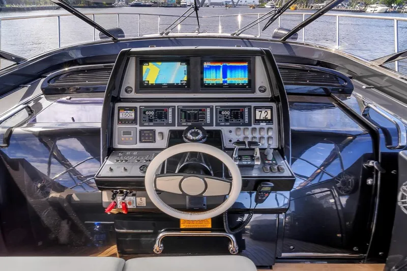 Slide: The Image of Cockpit of 2015 Riva 63 yacht with advanced navigation systems and steering wheel. - 41