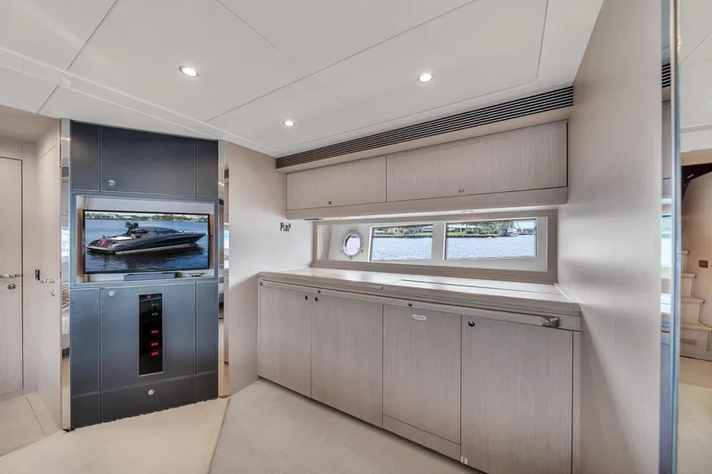 Slide: The Image of Luxurious interior of 2015 Riva 63 yacht with modern cabinetry and scenic window view. - 50