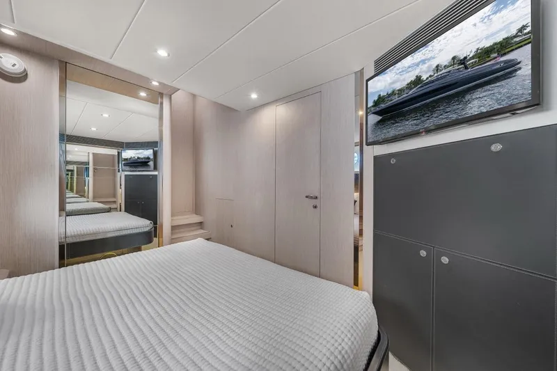 Slide: The Image of Luxurious interior of 2015 Riva 63 yacht bedroom with modern decor and TV. - 59