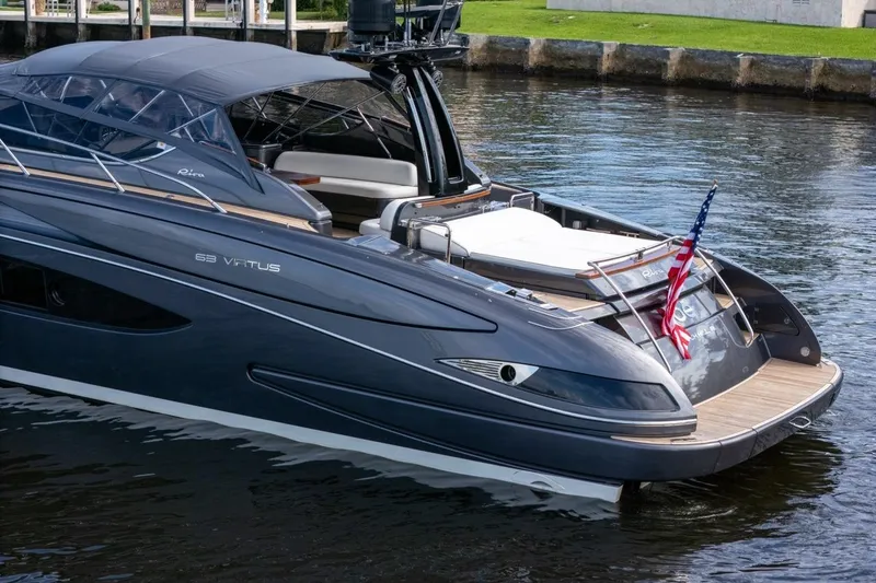 Slide: The Image of Luxurious 2015 Riva 63 yacht on water, featuring sleek design and American flag. - 6