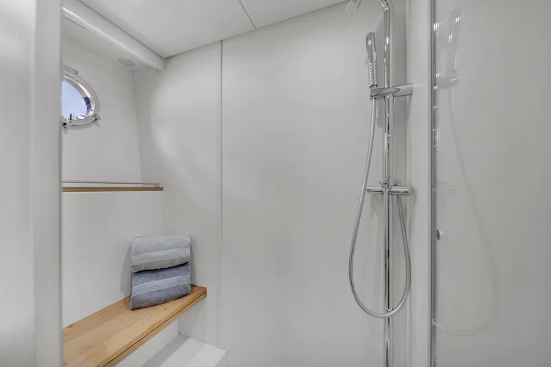 Slide: The Image of Luxurious 2015 Riva 63 yacht bathroom with modern shower and wooden bench. - 61