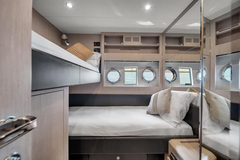 Slide: The Image of Luxurious cabin interior of 2015 Riva 63 yacht with modern design and porthole windows. - 64