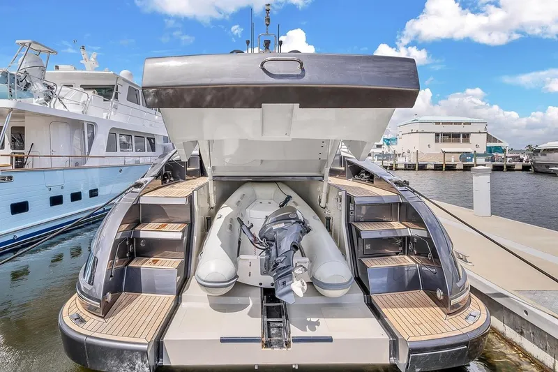 Slide: The Image of 2015 Riva 63 yacht with open stern garage, docked at marina under blue sky. - 66