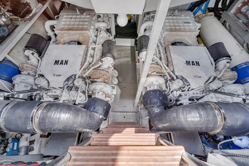 Slide: The Image of Engine room of a 2015 Riva 63 yacht featuring dual MAN V12 engines. - 67
