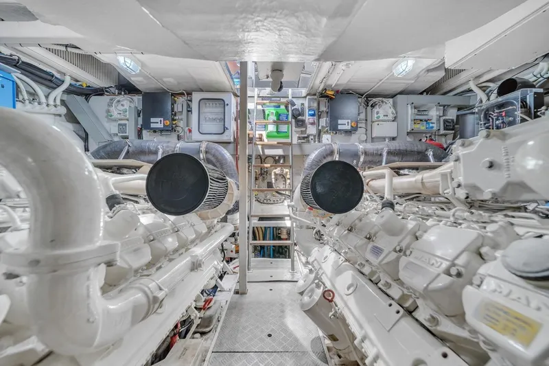 Slide: The Image of Engine room of a 2015 Riva 63 yacht, showcasing dual engines and mechanical systems. - 68