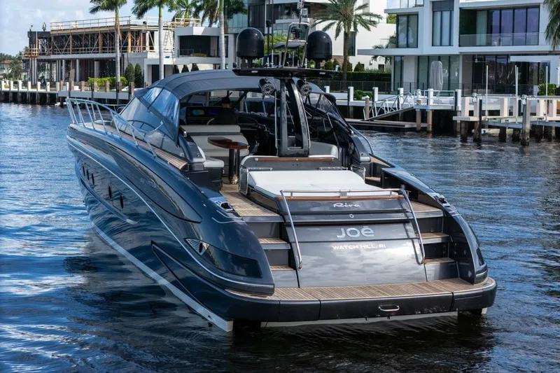 Slide: The Image of Luxury 2015 Riva 63 yacht docked in a scenic waterfront setting. - 7