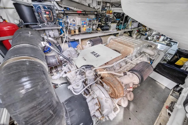 Slide: The Image of Engine room of a 2015 Riva 63 yacht, featuring a MAN engine. - 70