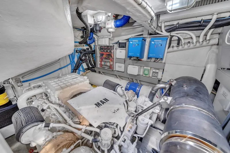 Slide: The Image of Engine room of a 2015 Riva 63 yacht, featuring MAN engine and electrical systems. - 71