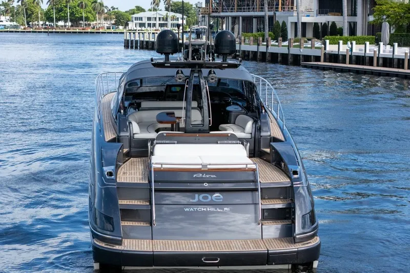 Slide: The Image of Luxury 2015 Riva 63 yacht cruising on a scenic waterway. - 9