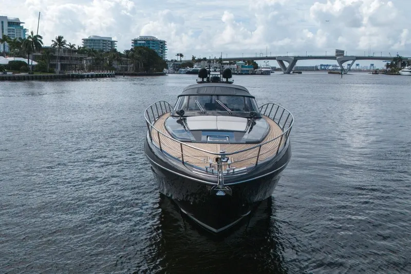 Slide: The Image of Luxury 2015 Riva 63 yacht on calm waters with cityscape and bridge background. - 23