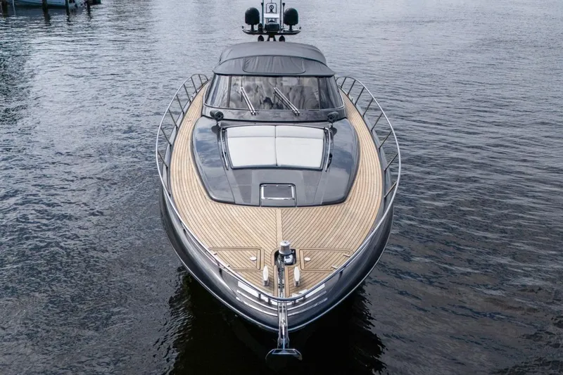 Slide: The Image of Luxury 2015 Riva 63 yacht on calm water, showcasing sleek design and wooden deck. - 24