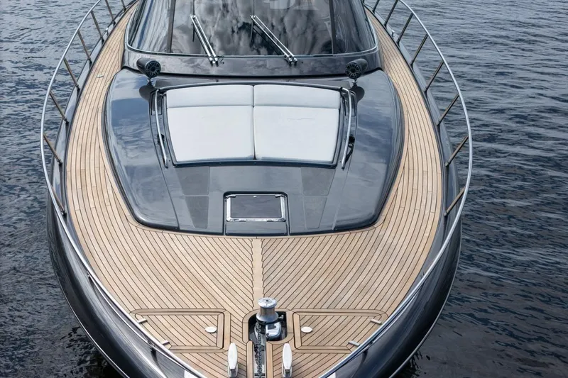 Slide: The Image of Luxurious 2015 Riva 63 yacht with sleek design and wooden deck on calm water. - 25