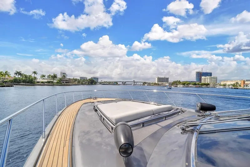 Slide: The Image of Luxurious 2015 Riva 63 yacht cruising on a sunny day with cityscape views. - 27