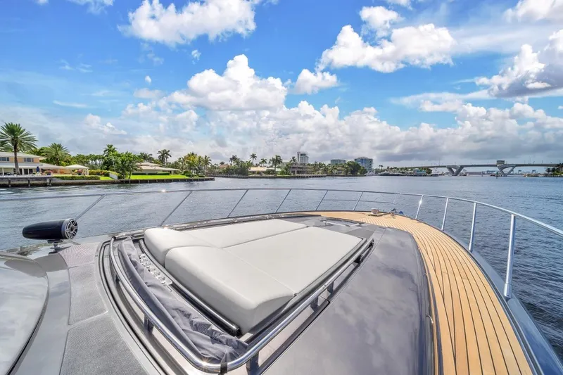 Slide: The Image of Luxurious 2015 Riva 63 yacht cruising on a sunny day with scenic waterfront views. - 28