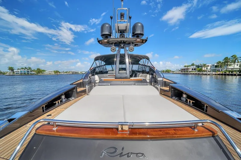 Slide: The Image of Luxurious 2015 Riva 63 yacht on a sunny day, featuring sleek design and spacious deck. - 31