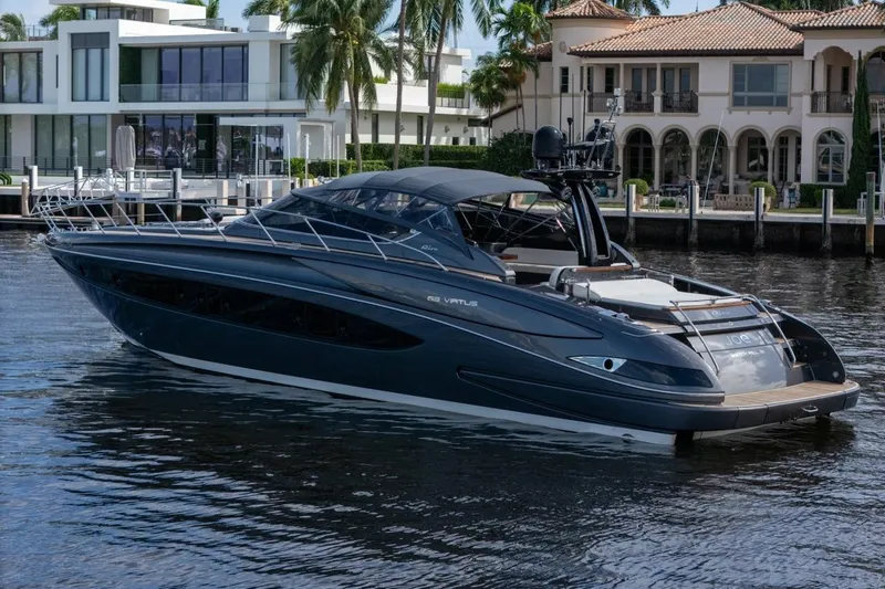 Slide: The Image of Luxury 2015 Riva 63 yacht docked near waterfront homes. - 4