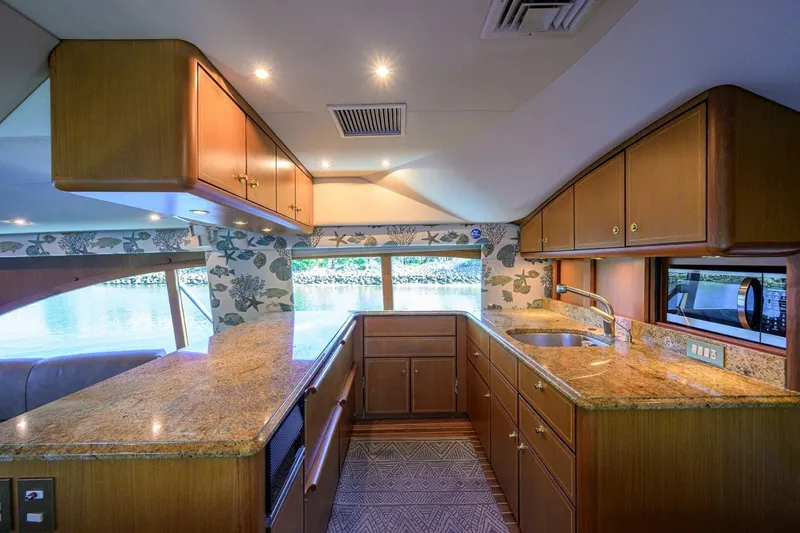 Slide: The Image of Luxurious kitchen interior of 2006 Ocean Yachts 57 Super Sport with wood cabinetry and granite countertops. - 3