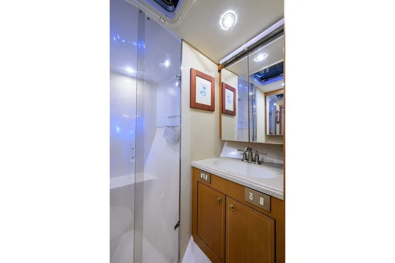 Slide: The Image of Luxurious bathroom in 2006 Ocean Yachts 57 Super Sport with modern fixtures and wood cabinetry. - 40