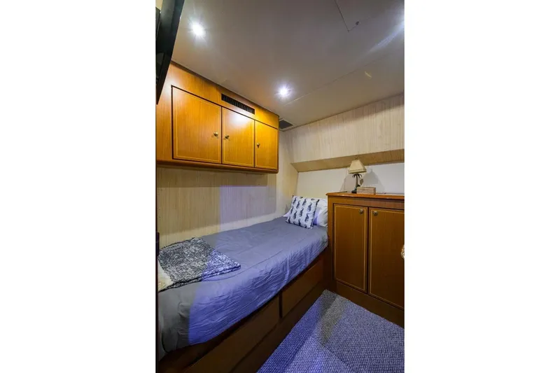 Slide: The Image of Cozy cabin interior of 2006 Ocean Yachts 57 Super Sport with wooden cabinets and bed. - 41