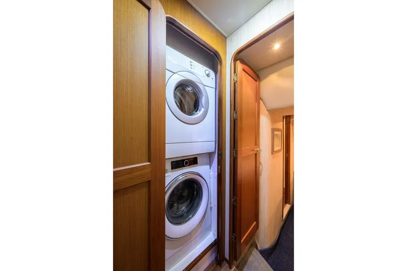 Slide: The Image of Laundry area inside 2006 Ocean Yachts 57 Super Sport, featuring stacked washer and dryer. - 43