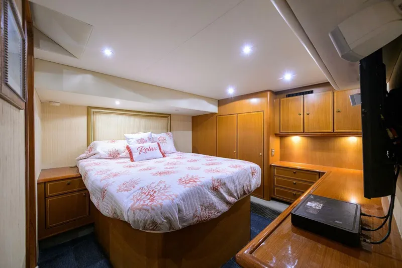 Slide: The Image of Luxurious bedroom interior of 2006 Ocean Yachts 57 Super Sport with cozy bedding and wooden cabinetry. - 44