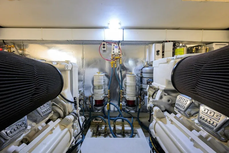 Slide: The Image of Engine room of 2006 Ocean Yachts 57 Super Sport, featuring dual engines and mechanical components. - 50