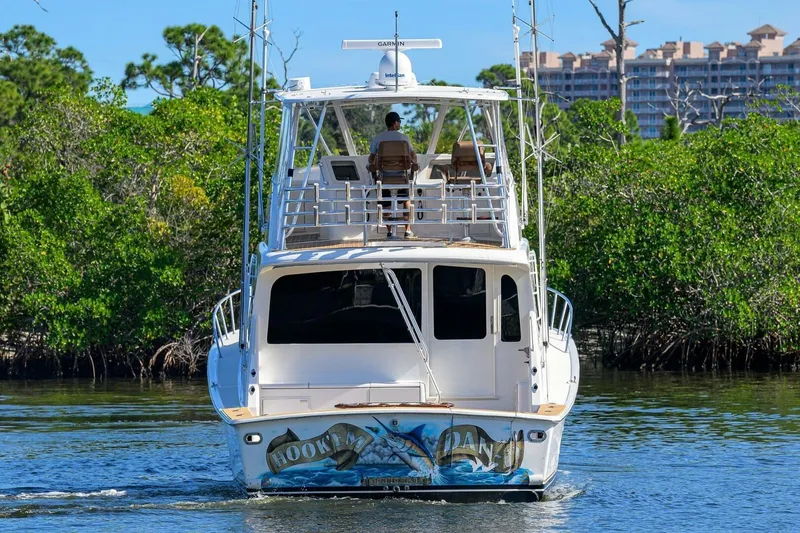 Slide: The Image of 2006 Ocean Yachts 57 Super Sport cruising on a scenic waterway with lush greenery. - 9