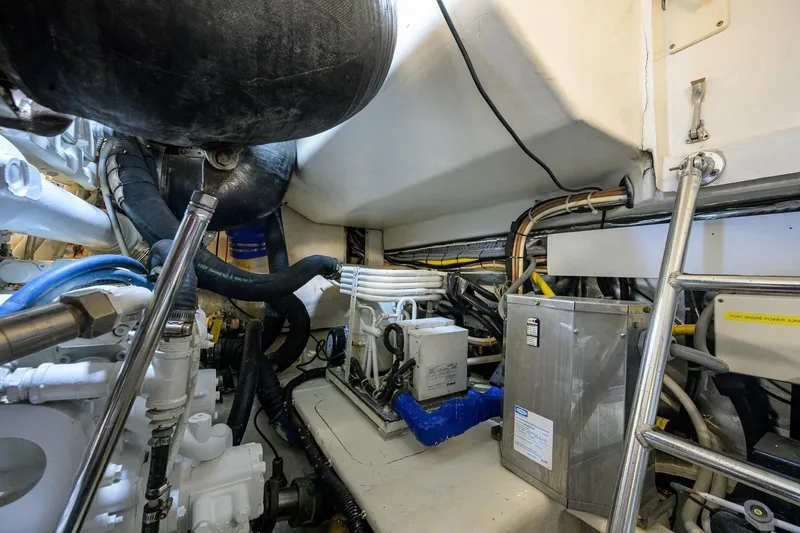 Slide: The Image of Engine room of 2006 Ocean Yachts 57 Super Sport, showcasing mechanical components and wiring. - 56