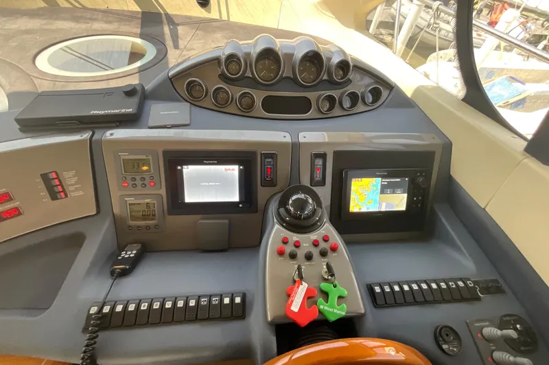 Slide: The Image of Control panel of a 2005 Azimut Fly 50 yacht with navigation and communication equipment. - 16