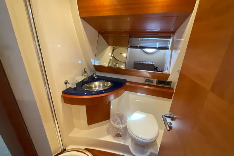 Slide: The Image of Luxurious 2005 Azimut Fly 50 yacht bathroom with modern fixtures and elegant wood accents. - 22