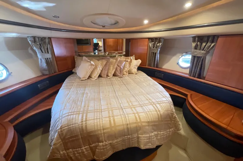 Slide: The Image of Luxurious bedroom interior of 2005 Azimut Fly 50 yacht with elegant bedding and wood accents. - 23