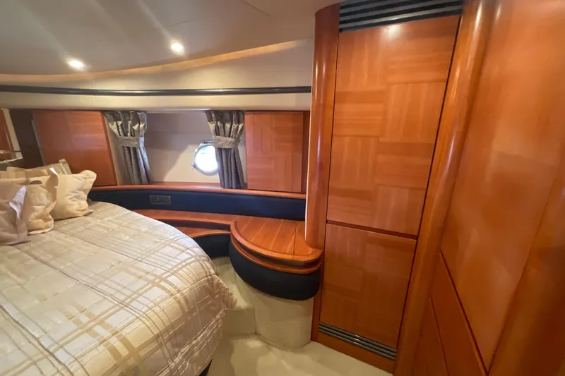 Slide: The Image of Luxurious 2005 Azimut Fly 50 yacht cabin with elegant wood paneling and cozy bedding. - 24