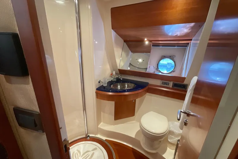 Slide: The Image of Luxurious bathroom in 2005 Azimut Fly 50 yacht with modern fixtures and porthole window. - 26