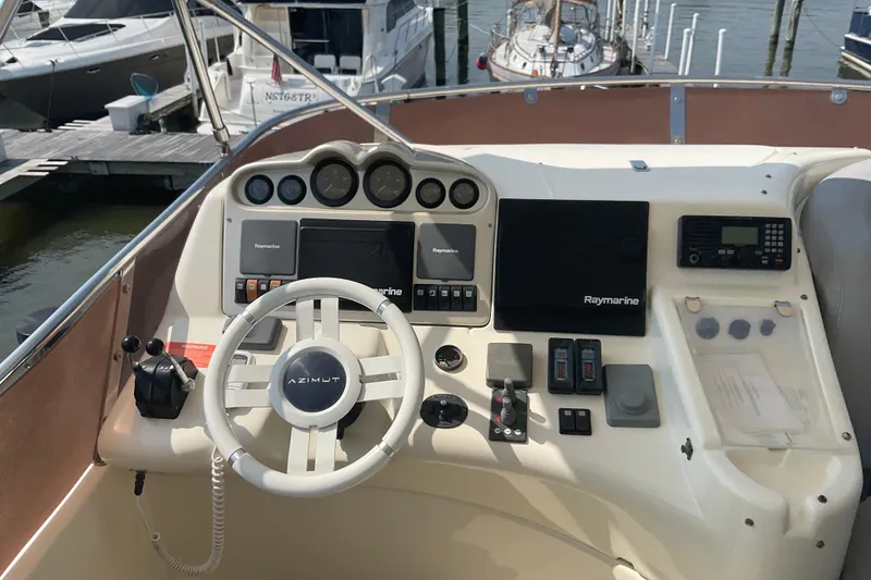 Slide: The Image of Cockpit of 2005 Azimut Fly 50 yacht with steering wheel and navigation controls. - 28