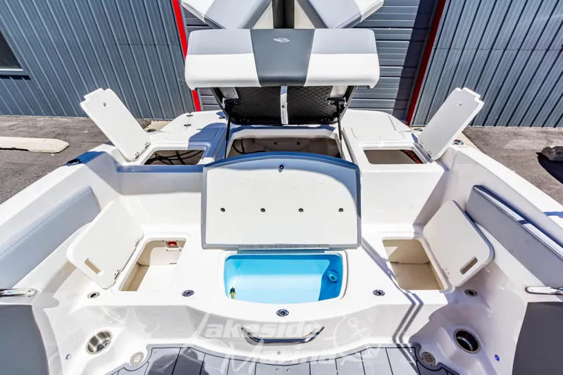 Slide: The Image of 2024 Chaparral 19 SSi OB boat interior with open storage compartments and seating. - 14