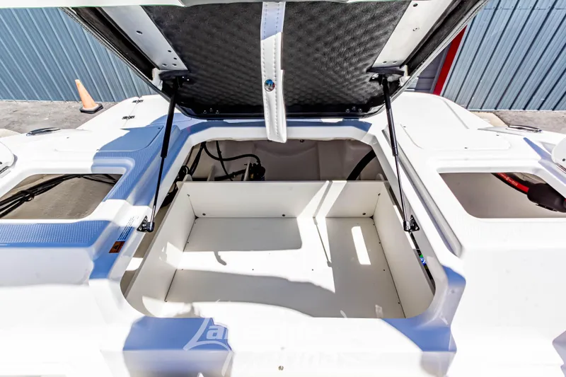 Slide: The Image of 2024 Chaparral 19 SSi OB boat storage compartment open, showcasing spacious interior. - 15
